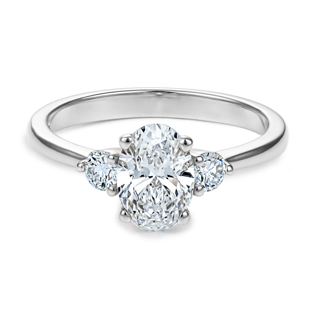 Trinity ring with 1.00 Ct oval center diamond and round side diamonds