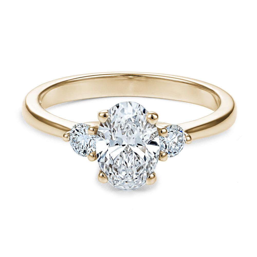 Trinity ring with 1.00 Ct oval center diamond and round side diamonds