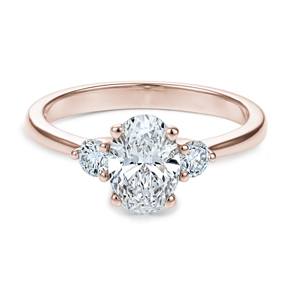Trinity ring with 1.00 Ct oval center diamond and round side diamonds