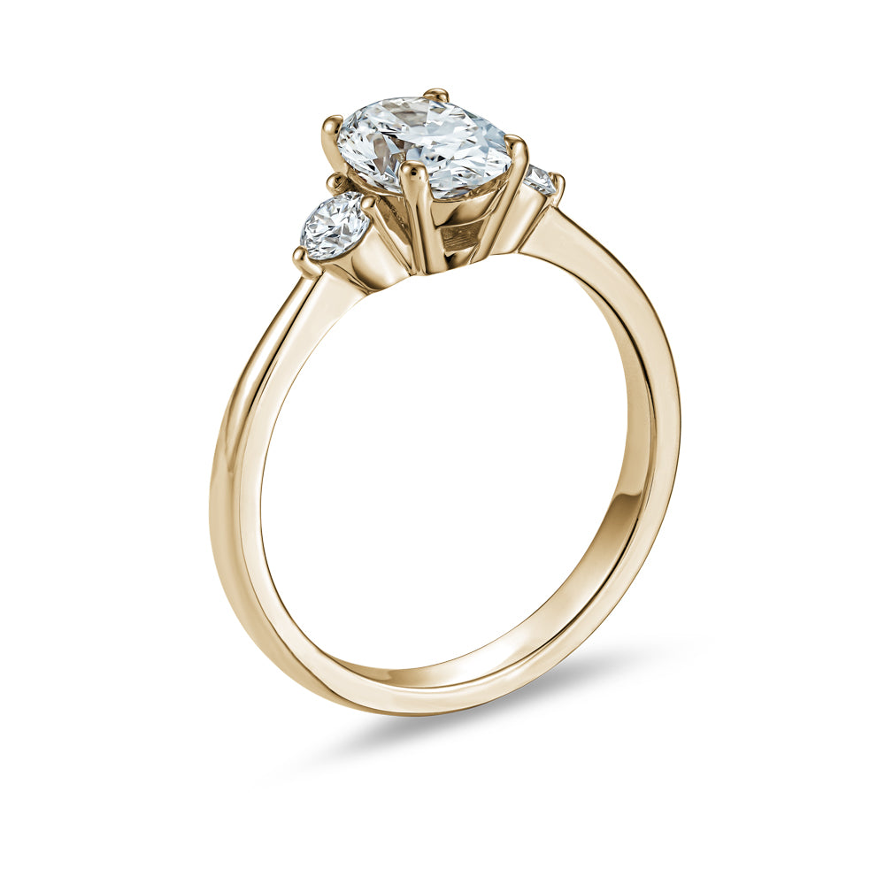 Trinity ring with 1.00 Ct oval center diamond and round side diamonds